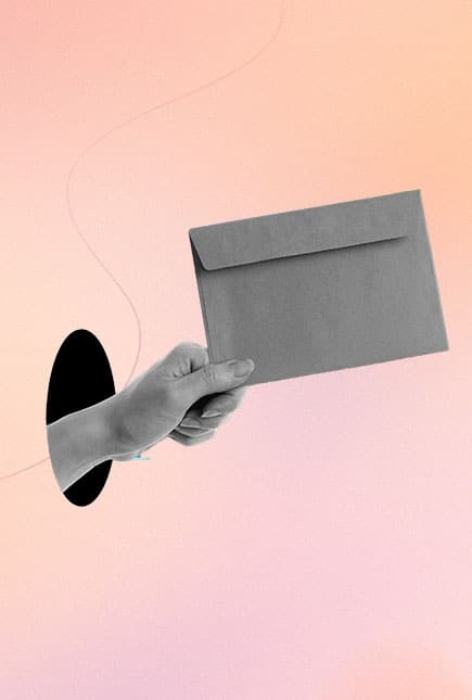 Hand holding letter on pink background.